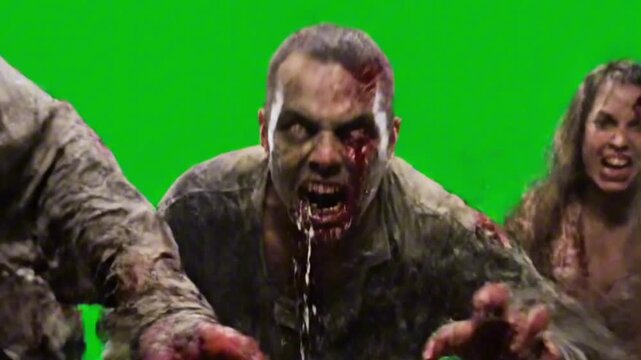 Three zombies running towards the camera on a green screen background for special effects use