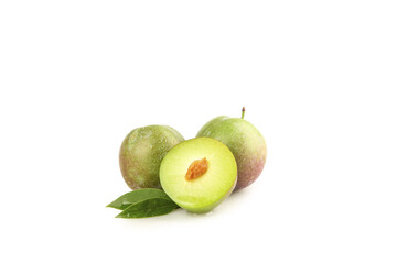 Fresh Green Plums Cut in Half Showing Pit with Leaves on White Background