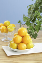 Fresh Golden Apricots on White Plate with Natural Green Background