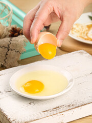 Fresh Farm Eggs Being Cracked and Separated in Rustic Farmhouse Kitchen for Cooking and Baking Preparation