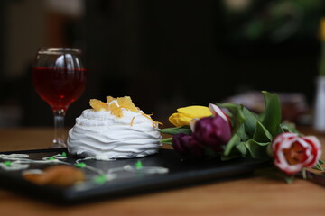 Elegant Pavlova Dessert with Wine and Tulips