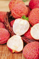 Fresh Lychee Fruit Display in Wicker Basket - Exotic Tropical Asian Fruit with Red Textured Skin and White Flesh