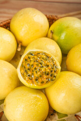 Fresh Golden Passion Fruits from Fujian China in Basket with Cut Open Fruit Showing Juicy Pulp and Seeds