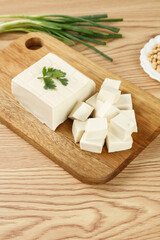 Handmade Tofu Block and Cubes on Wooden Board - Traditional Shandong Farmhouse Cooking Ingredient with Fresh Herbs