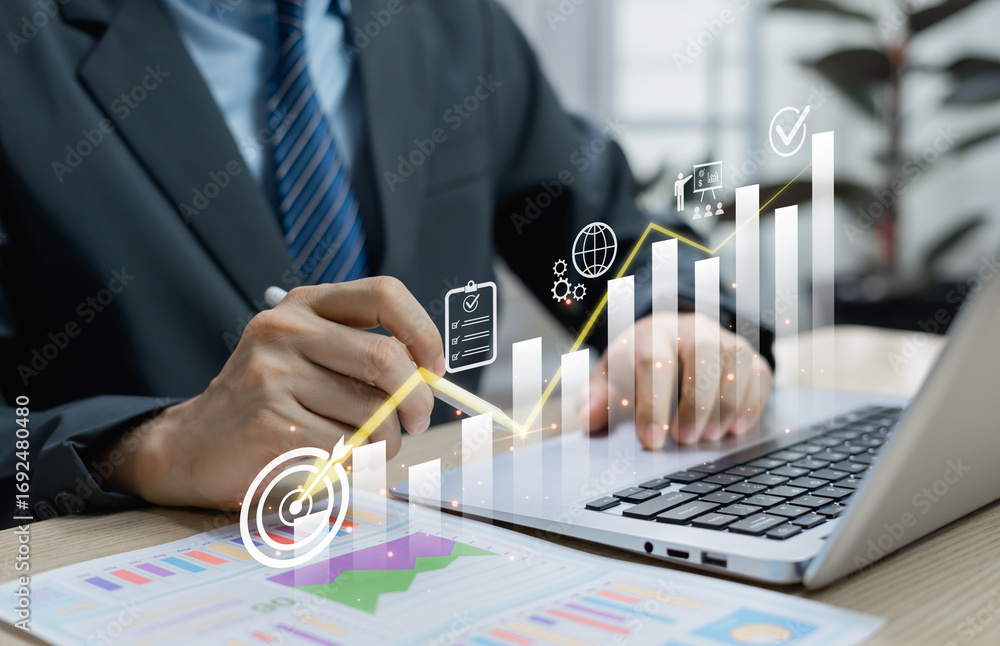 Poster businessman using virtual screen with cost reduction graph and down arrow representing business fina