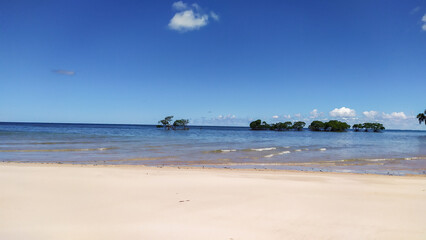 The wild coastline of Castelhanos Beach opens to breathtaking blue horizons on Boipeba Island, Bahia.