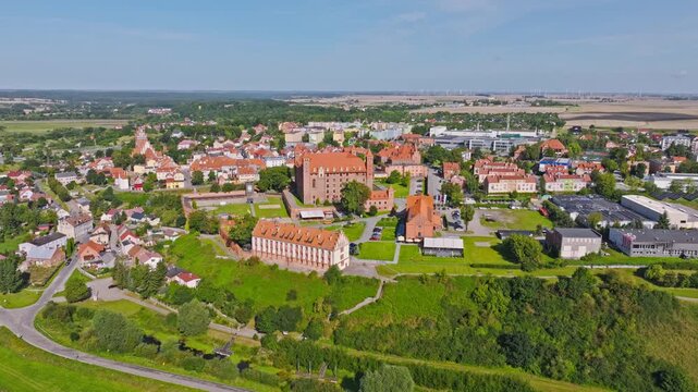 Cinematic drone view of medieval Gniew Castle and surrounding historic old town