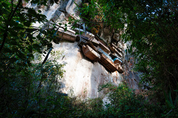 Mystical cliff site with hanging coffins and secret rituals