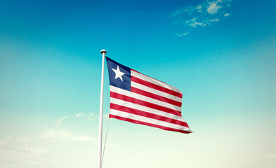 Liberia national flag waving in beautiful sky with mast. A proud moment flag waving with sunlight.