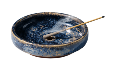 Incense stick burning in a ceramic bowl with smoke rising gently up isolated on transparent background