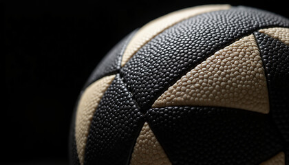 Closeup of a rugby ball with textured surface on black background
