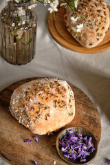 Homemade sourdough bread with viola, side view.