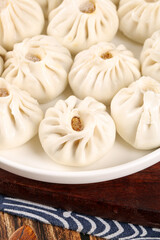 Fresh Xiaolongbao Chinese Soup Dumplings with Meat Filling on White Plate
