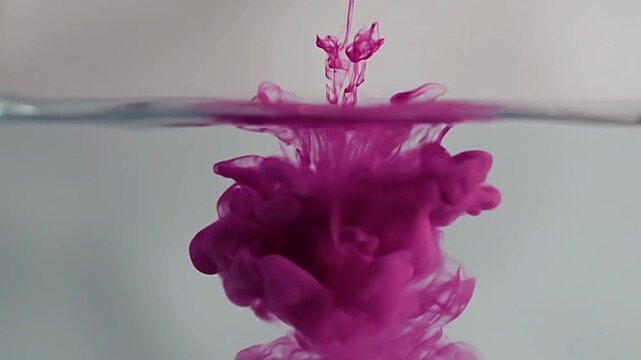 Pink ink cloud diffusion in water with creative abstract style