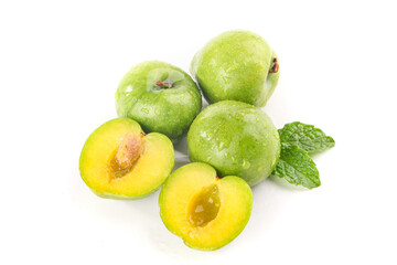 Fresh Green Plums with Yellow Flesh and Mint Leaves on White Background
