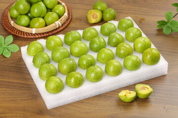 Fresh Green Sichuan Plums on Cutting Board - Organic Fruit Harvest Display