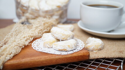 Homemade Putri Salju cookies coated in powdered sugar, and with hot black coffee. Perfect for festive food promotions and design assets