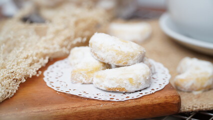 Homemade Putri Salju cookies coated in powdered sugar, and with hot black coffee. Perfect for...