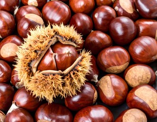Close-up of many chestnuts, some opened