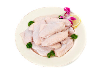 Fresh Raw Chicken Wings on White Plate with Herbs and Lemon Garnish