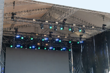 Modern LED and laser lighting equipment illuminating an outdoor concert stage