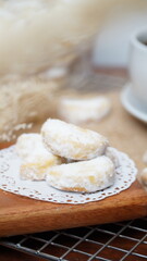 Homemade Putri Salju cookies coated in powdered sugar, and with hot black coffee. Perfect for festive food promotions and design assets
