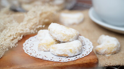 Homemade Putri Salju cookies coated in powdered sugar, and with hot black coffee. Perfect for festive food promotions and design assets