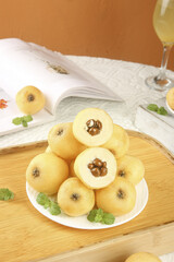 Fresh Loquat Fruits with White Flesh Display on Wooden Table Bottom View