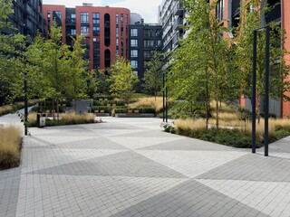  Background of Modern Urban Courtyard with Abstract Sculpture Surrounded by Lush Greenery and...