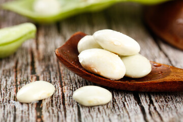 Fresh White Lima Beans in Wooden Spoon on Rustic Kitchen Table