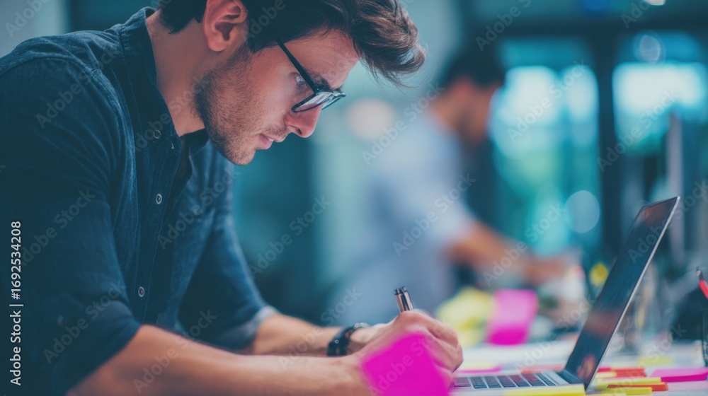 Poster focused medium shot of a developer sharing updates on a laptop during a hybrid standup while a blurr