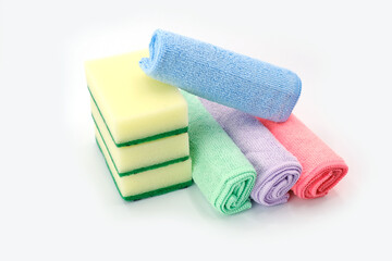 Yellow Dish Sponges and Rolled Colorful Fleece Towels on White Background