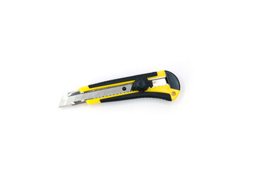 Yellow and black utility cutter knife with retractable blade, photographed on a clean white...