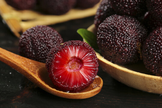 Fresh Red Bayberries on Wooden Spoons - Traditional Asian Fruit Display