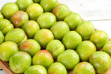 Fresh Xinjiang Green-Skinned Apricots Display in Wooden Basket - Organic Stone Fruit Harvest