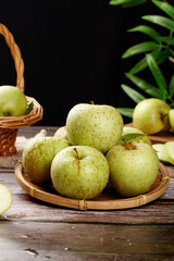 Fresh Green Apples from Jinshuai Shaanxi China in Wicker Baskets on Rustic Wood Table with Natural Sunlight