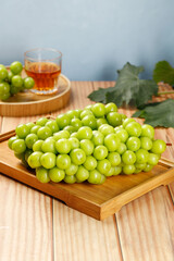 Fresh Green Grapes on Wooden Board with Tea Glass - Healthy Food Still Life Photography
