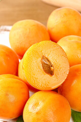 Fresh Shaanxi Apricots Display with Cut Fruit Showing Pit and Flesh