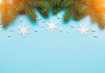 Green fir branches with white snowflakes on blue background. Minimal winter composition, natural pine needles, seasonal decoration, Christmas holiday concept with copy space for greeting card design