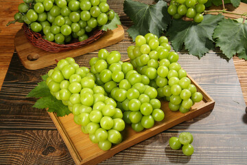Fresh Green Grapes on Wooden Boards with Vine Leaves - Organic Fruit Harvest Display