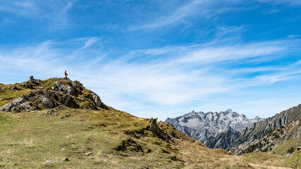 Alps landscape with hiker on silhouette, Val Masino, Italy
