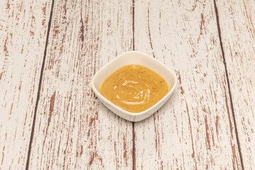 containers with smoky mayonnaise, revealing the slightly beige hue of the well-emulsified sauce