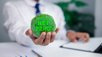 Business Person Holding Green Moss Globe with NET ZERO Text for Sustainability and Climate Action