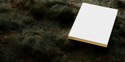 Blank book mockup placed on vegetation, notebook mockup. mockup on nature background 02 © TrongPhap