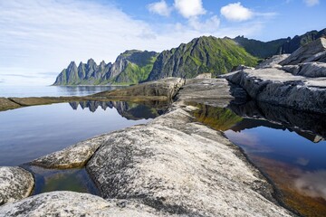 Reflection in a tidal pool, rocky coast of Tungeneset, Devil's Teeth, Okshornan, Ersfjorden, Senja Island, Troms, Norway