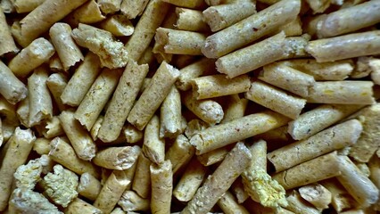 close up of broken yellow biomass pellets with rough texture and natural detail ideal for eco wallpaper or sustainable banner background