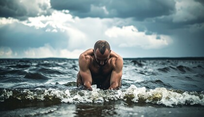 Shirtless man kneels in choppy water, dramatic sky