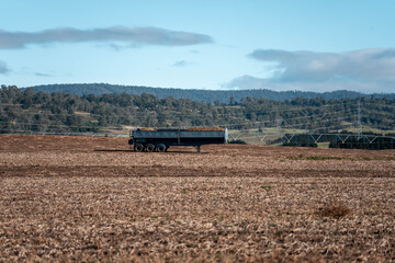 Fototapeta premium trailer in a paddock at harvest of potatoes on australia