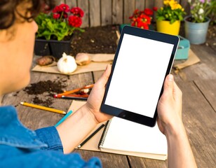 Person holding a tablet outdoors