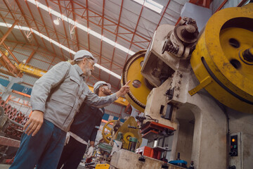Engineers and staff are inspecting systems and components in a metal sheet and metal roofing manufacturing plant.